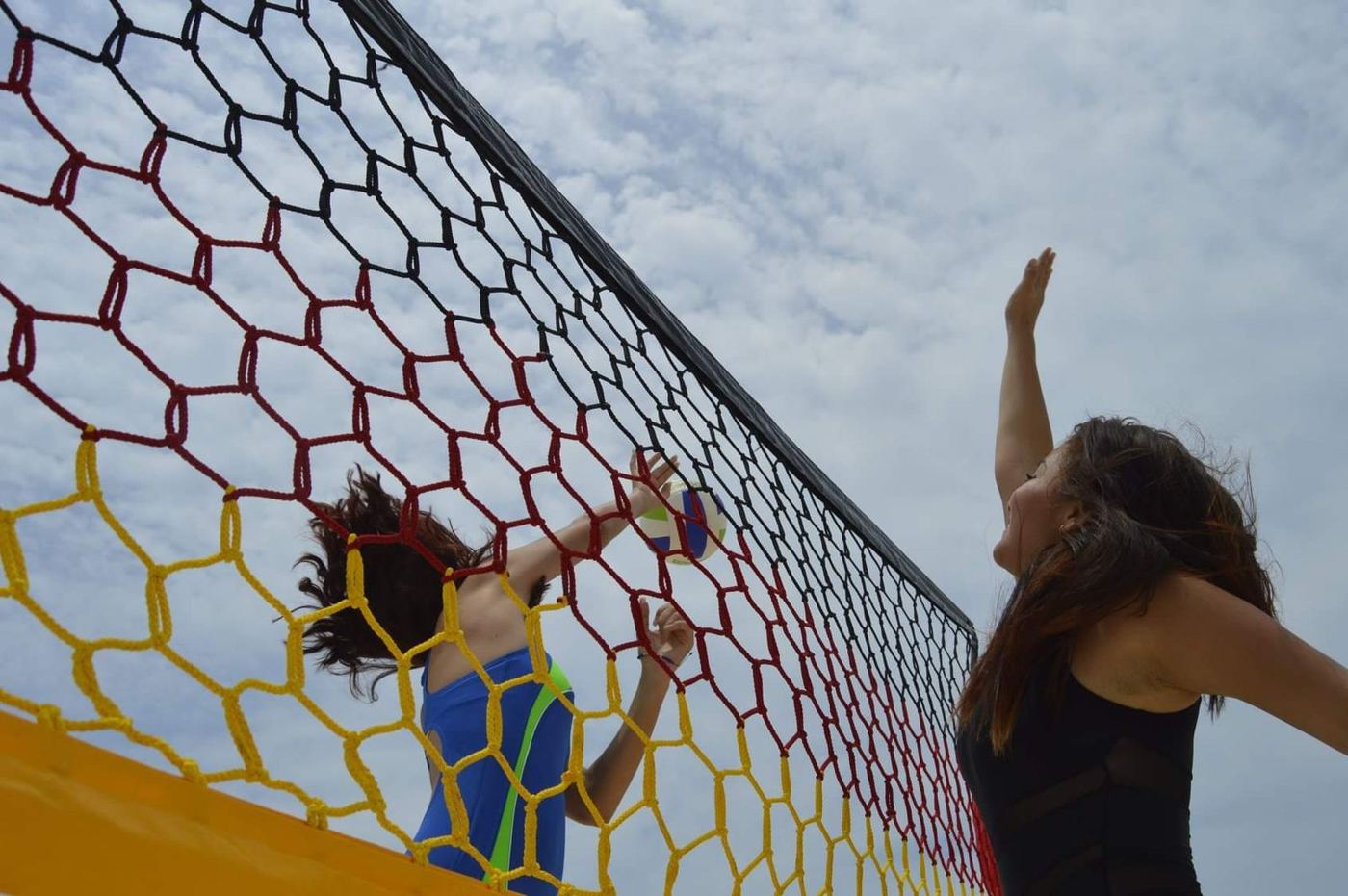 Bloqueo en una red de voleibol hexagonal roja, amarilla y negra